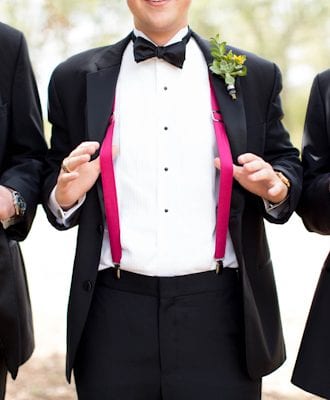 pink suspenders under grooms coat