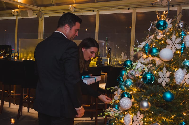 couple looking at christmas tree ornaments