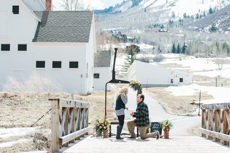 man on one knee in front of mountain