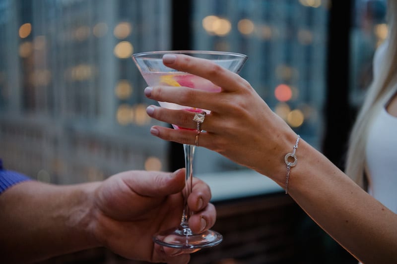 engaged gal drinking raspberry lemon drop martini