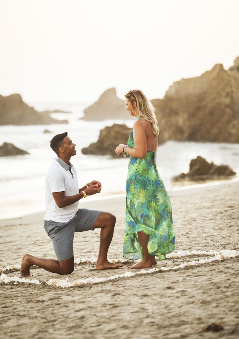 beach proposal with heart in sand