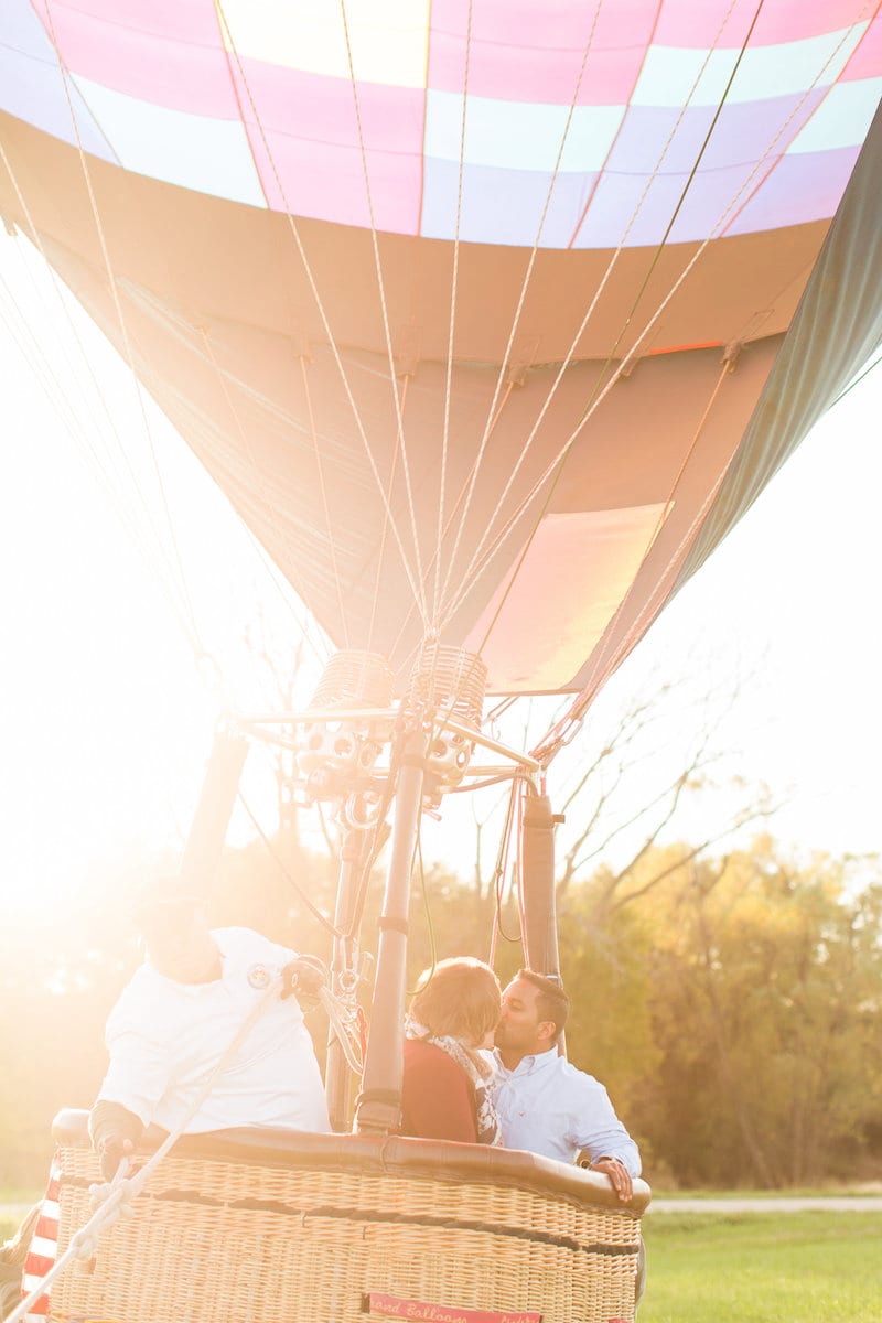 couple in hot air balloon kissing