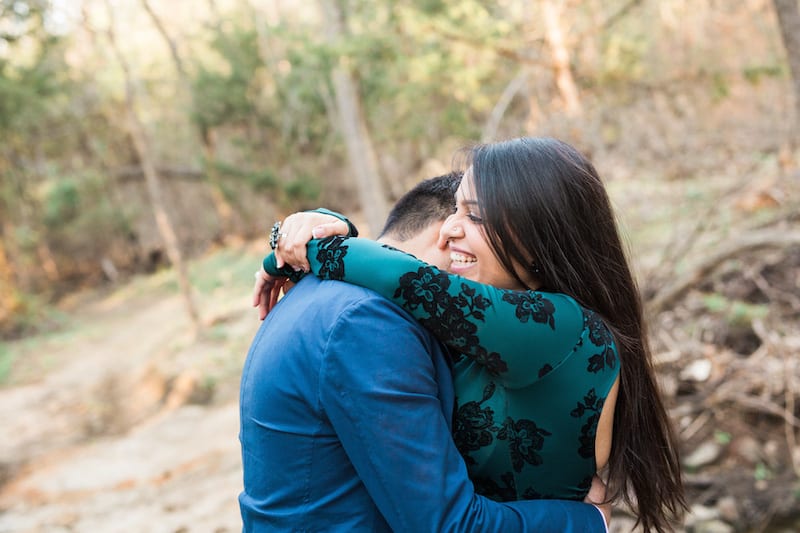 engaged man and woman hugging