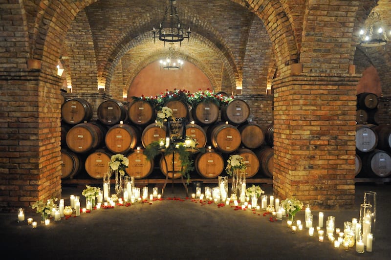 red roses candles wine barrels proposal