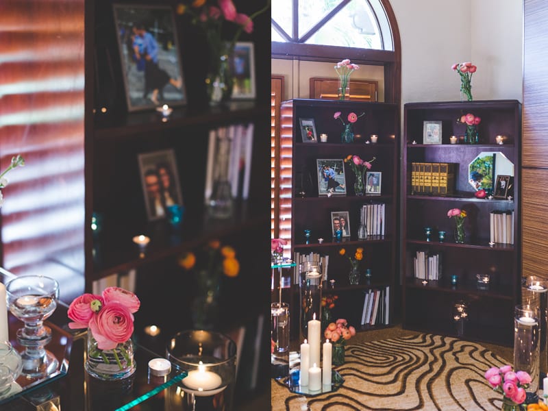 ranunculus and candles proposal decor on bookshelves