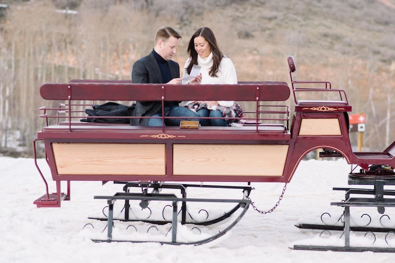 man reading greeting card to woman