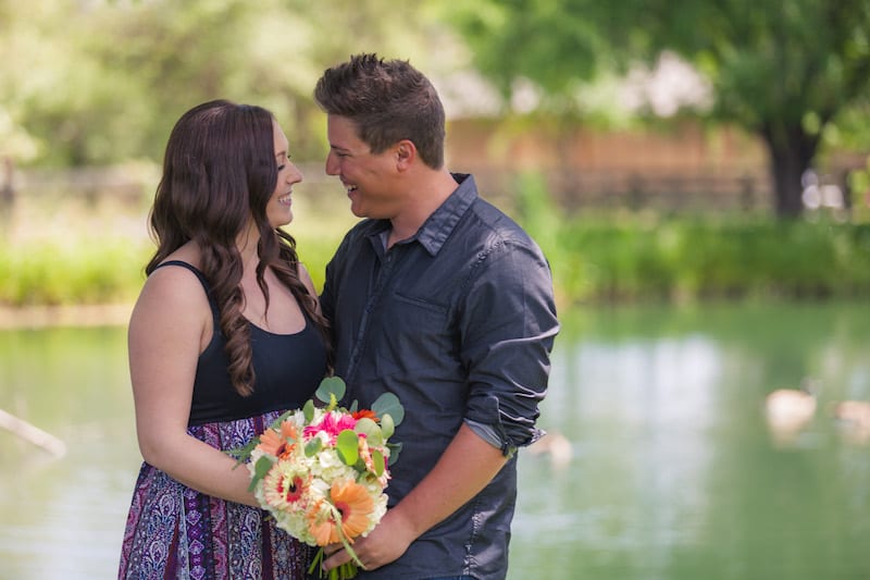 engaged couple near water in napa