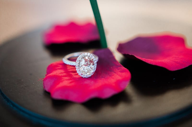 engagement ring on red rose petal