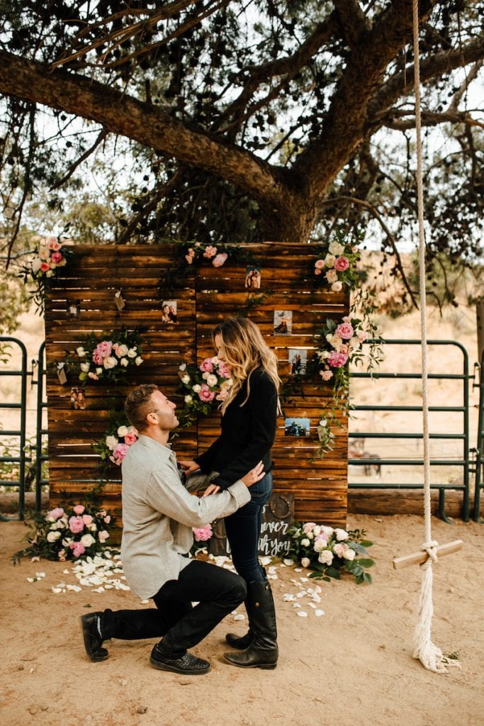 down on one knee rustic wooden wall proposal