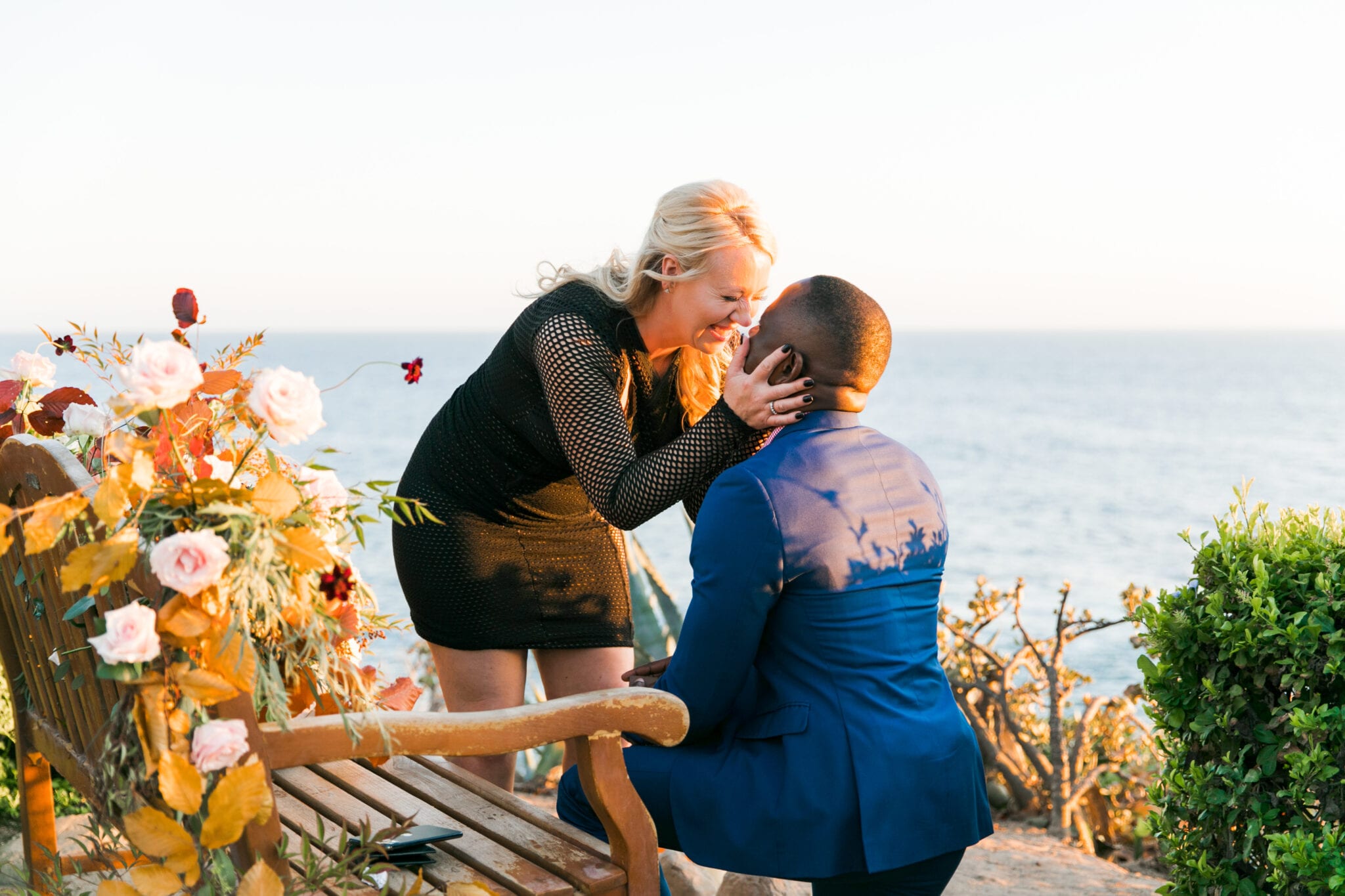 Man proposing in front of the ocean