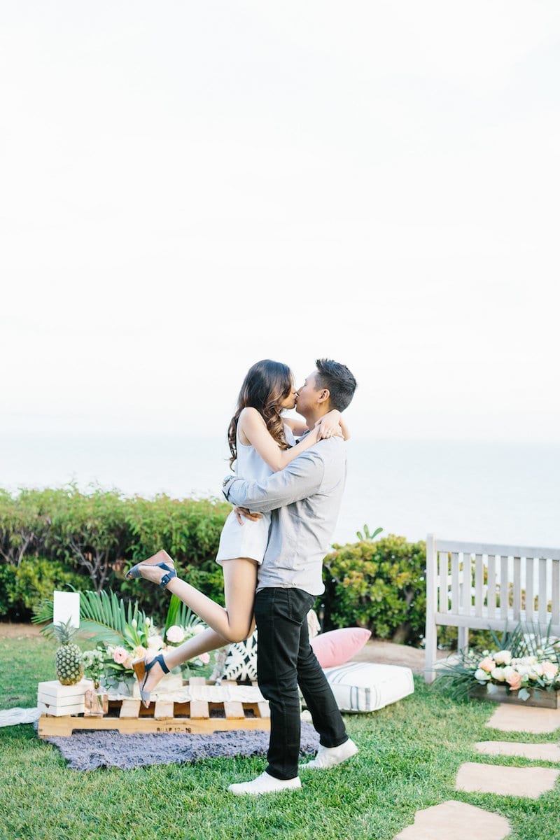 couple kissing in front of ocean