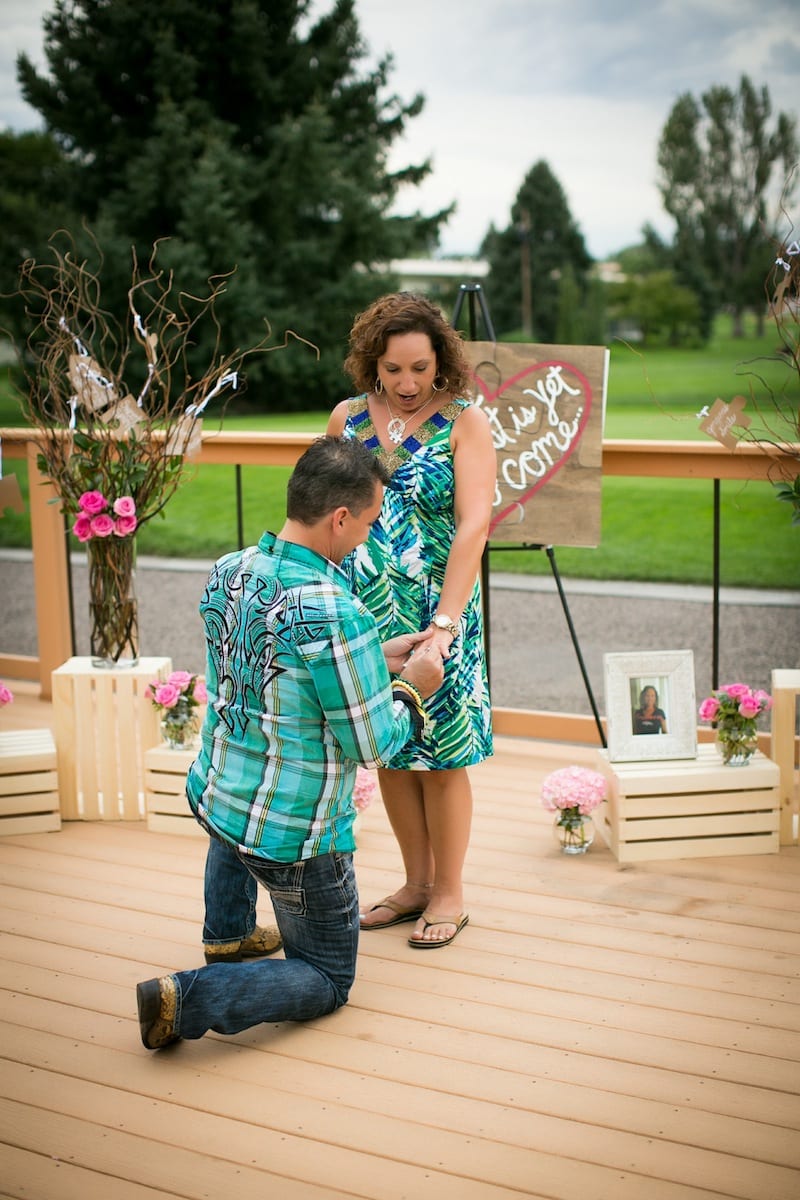 couple getting engaged on deck