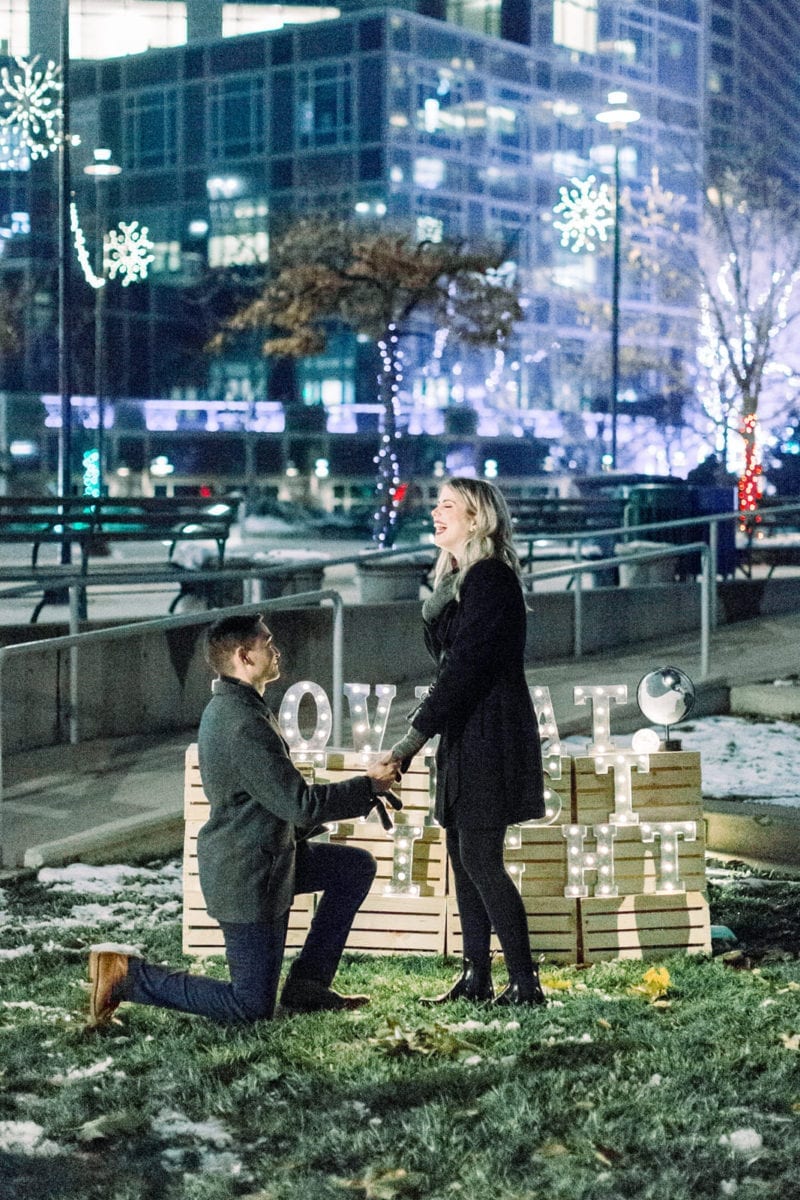 man proposing in twinkle lights