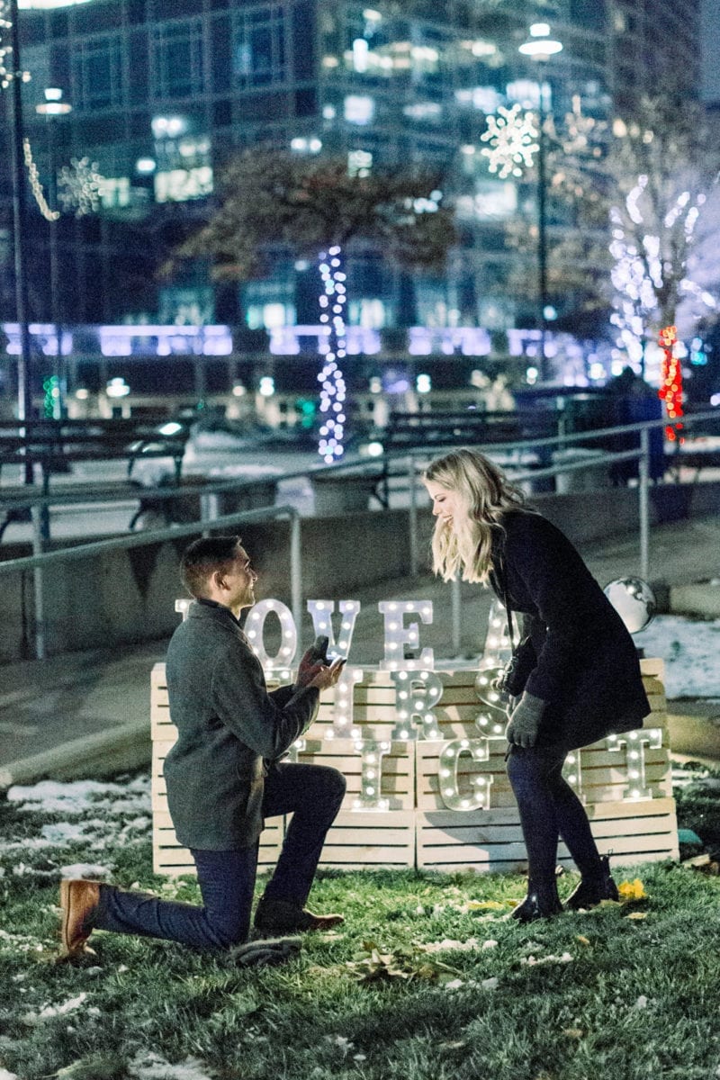 man proposing in twinkle lights