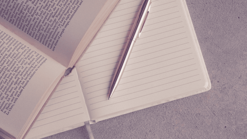 Book, paper and gold pen