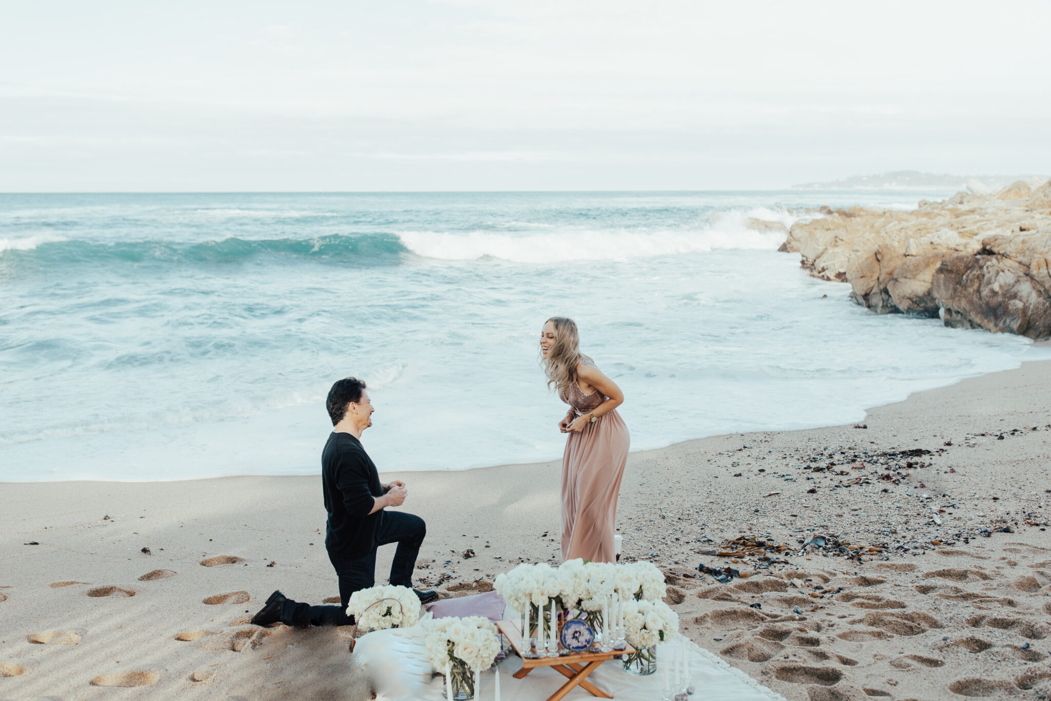 man proposing in sand