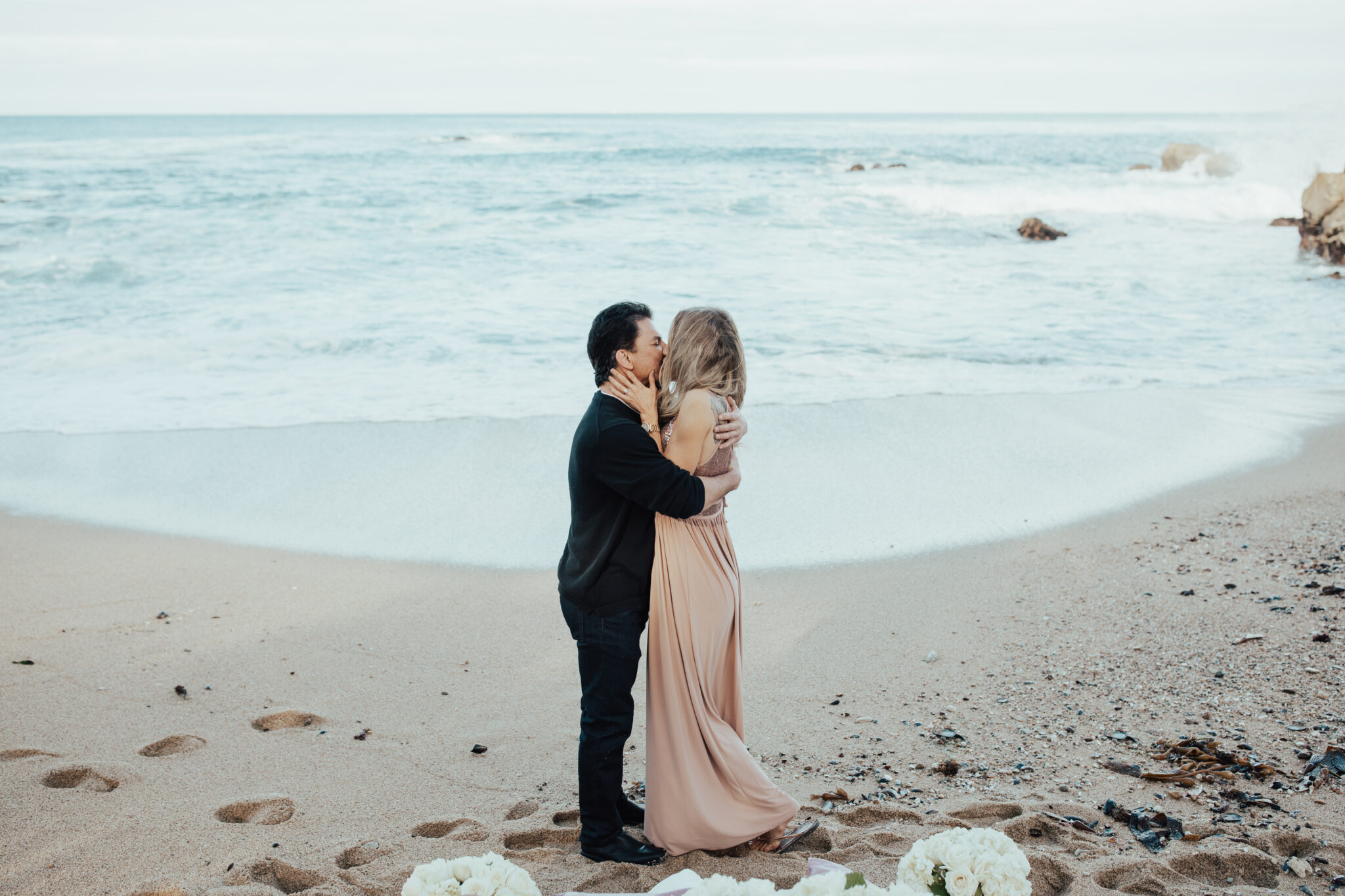 couple kissing in sand