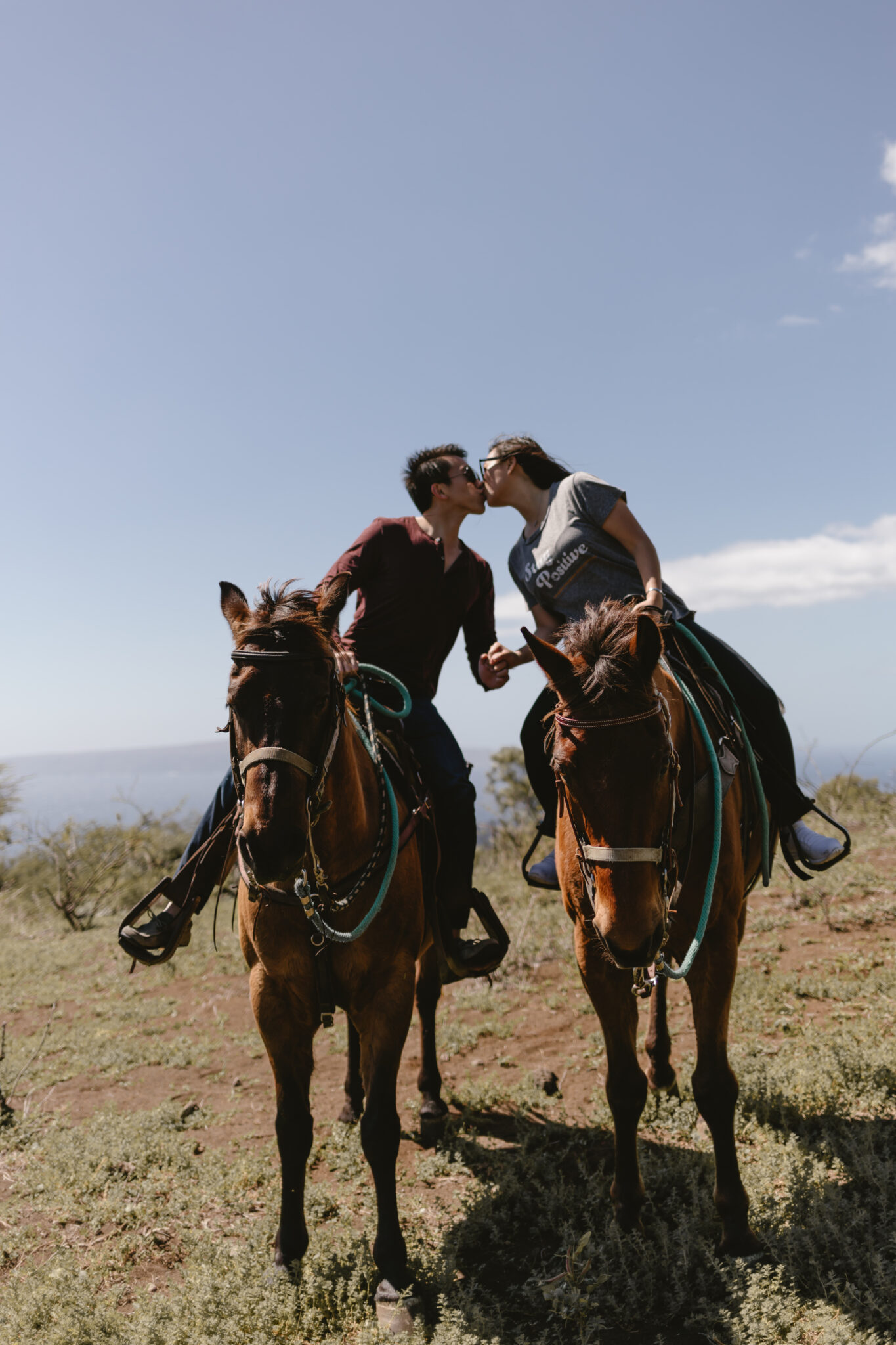 couple kissing on horses