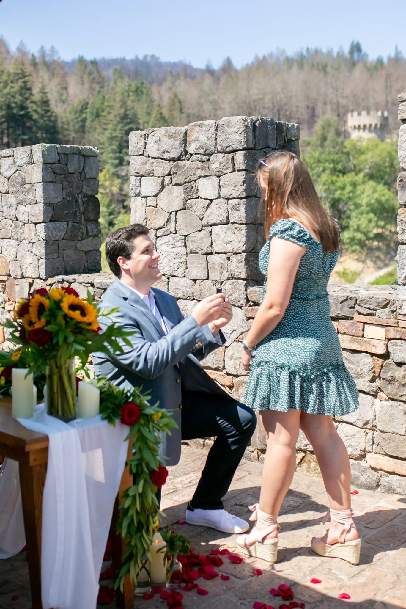 Man down on one knee for marriage proposal in Napa at a castle