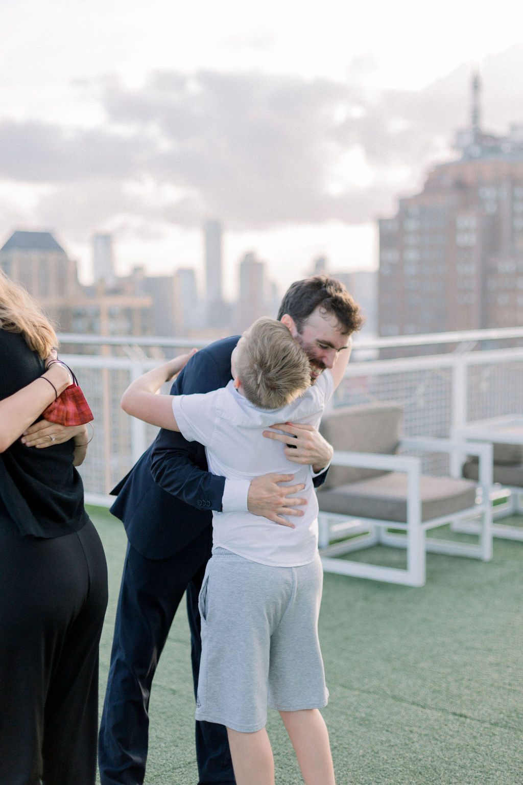 man embracing family at marriage proposal