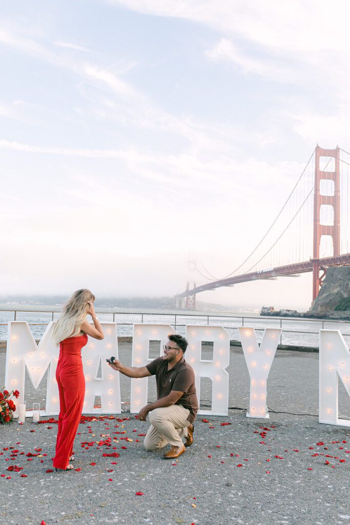 Man proposing in front of Golden Gate Bridge