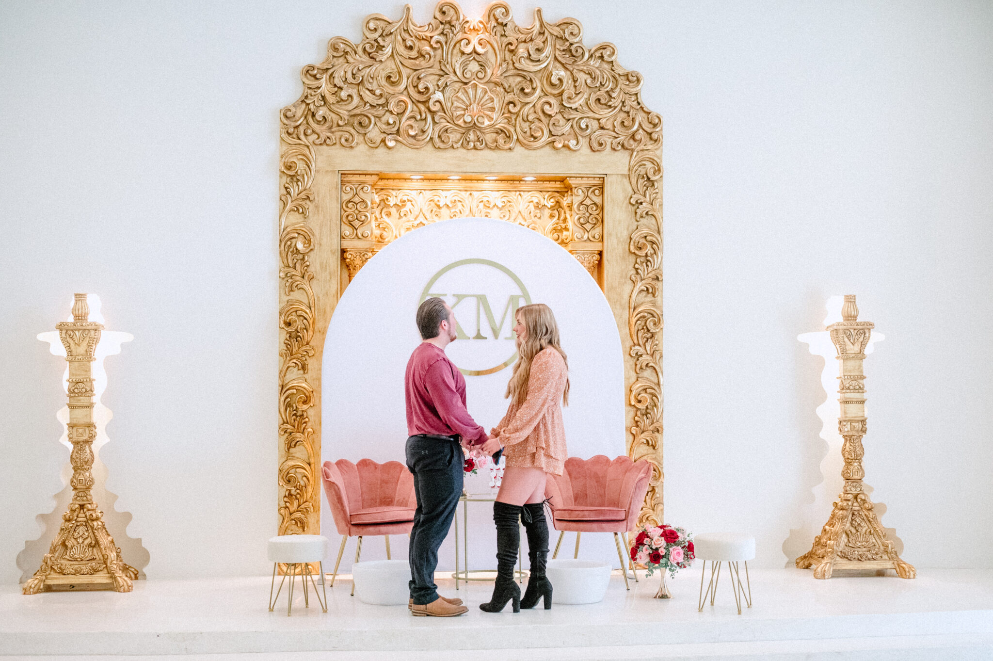 Couple standing in front of proposal backdrop