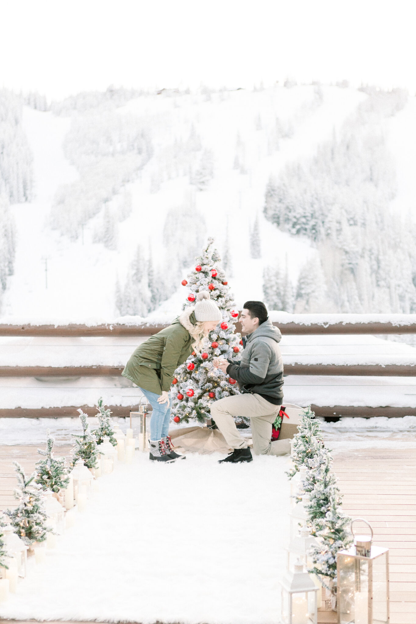 Man proposing in front of christmas tree