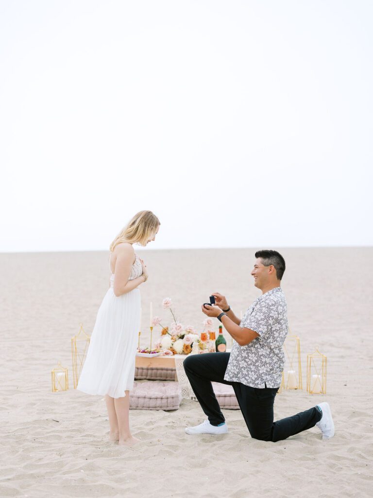 man proposing on beach