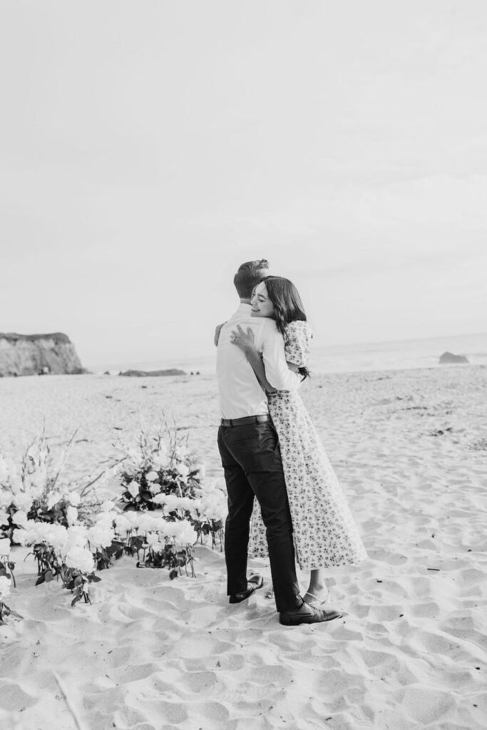 couple hugging after proposal on beach the yes girls