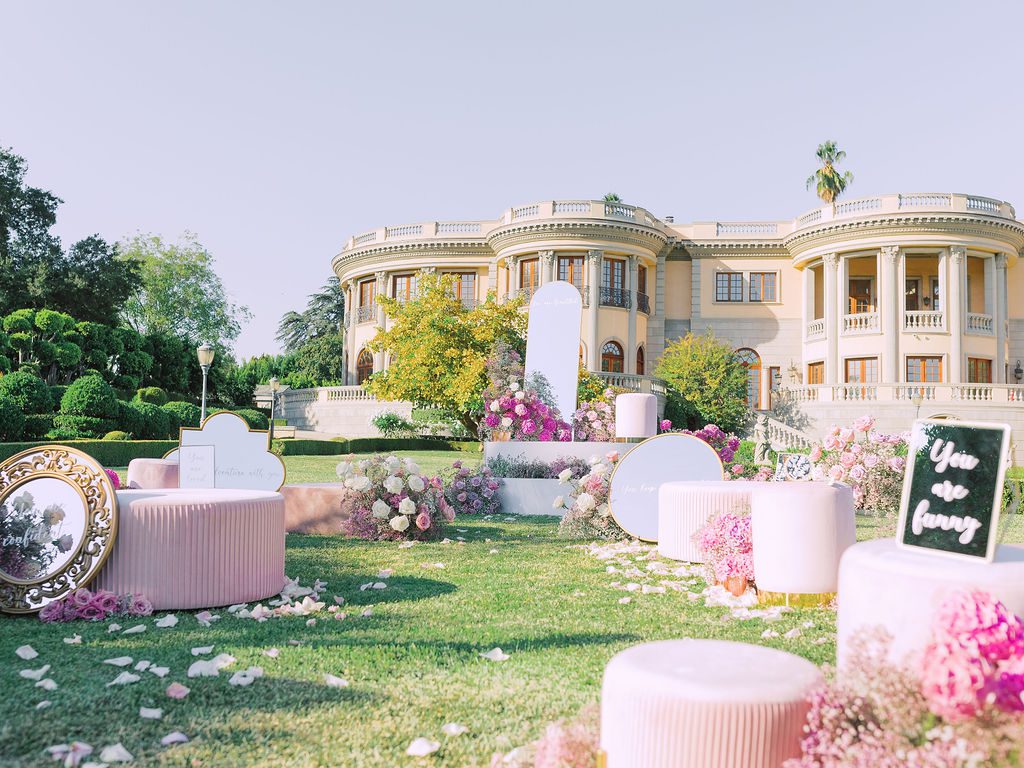 luxury pink flowers and signs re proposal in Los angeles set up by the yes girls