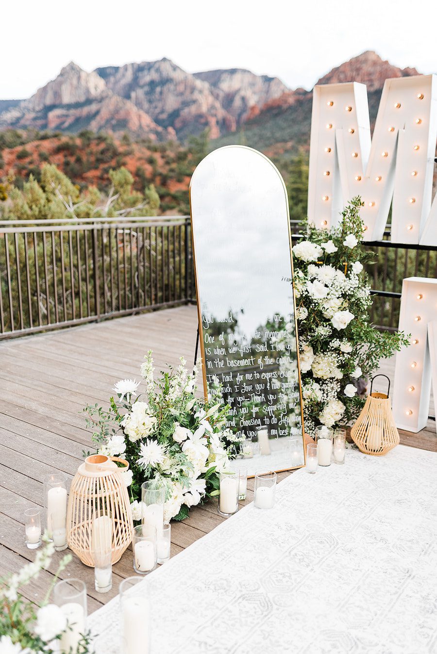 Writing on mirror white florals romantic candles Sedona Proposal