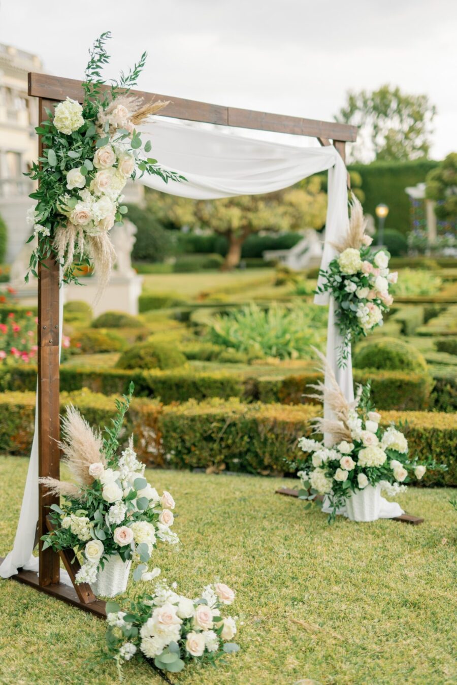 white and blush flowers arch with flowers proposal flowers white draping arch