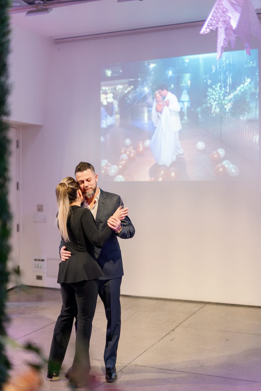 Their first dance all over again with a projection of their actual first dance playing in the background 