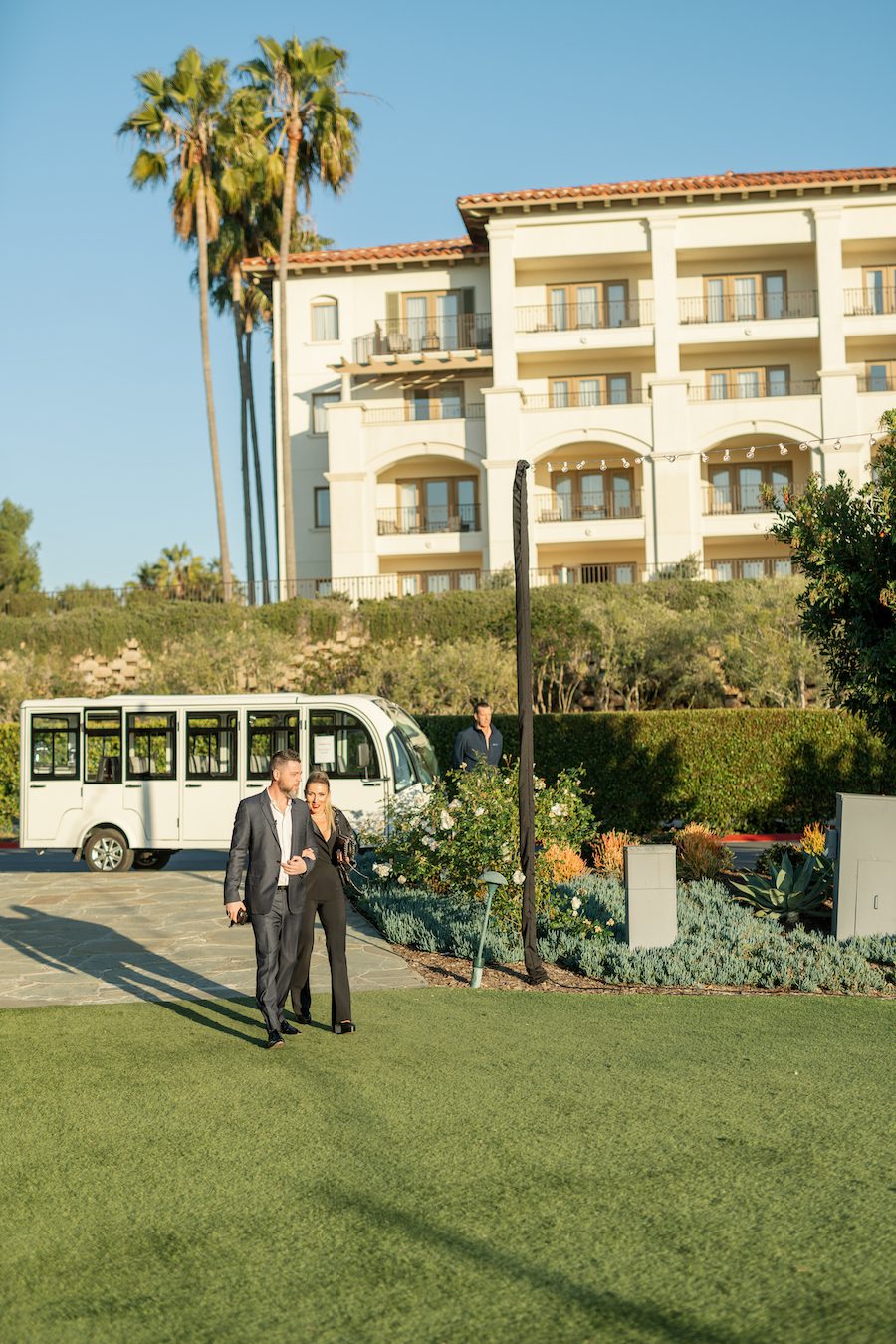 couple walking up to surprise proposal at ocean view lawn in orange county