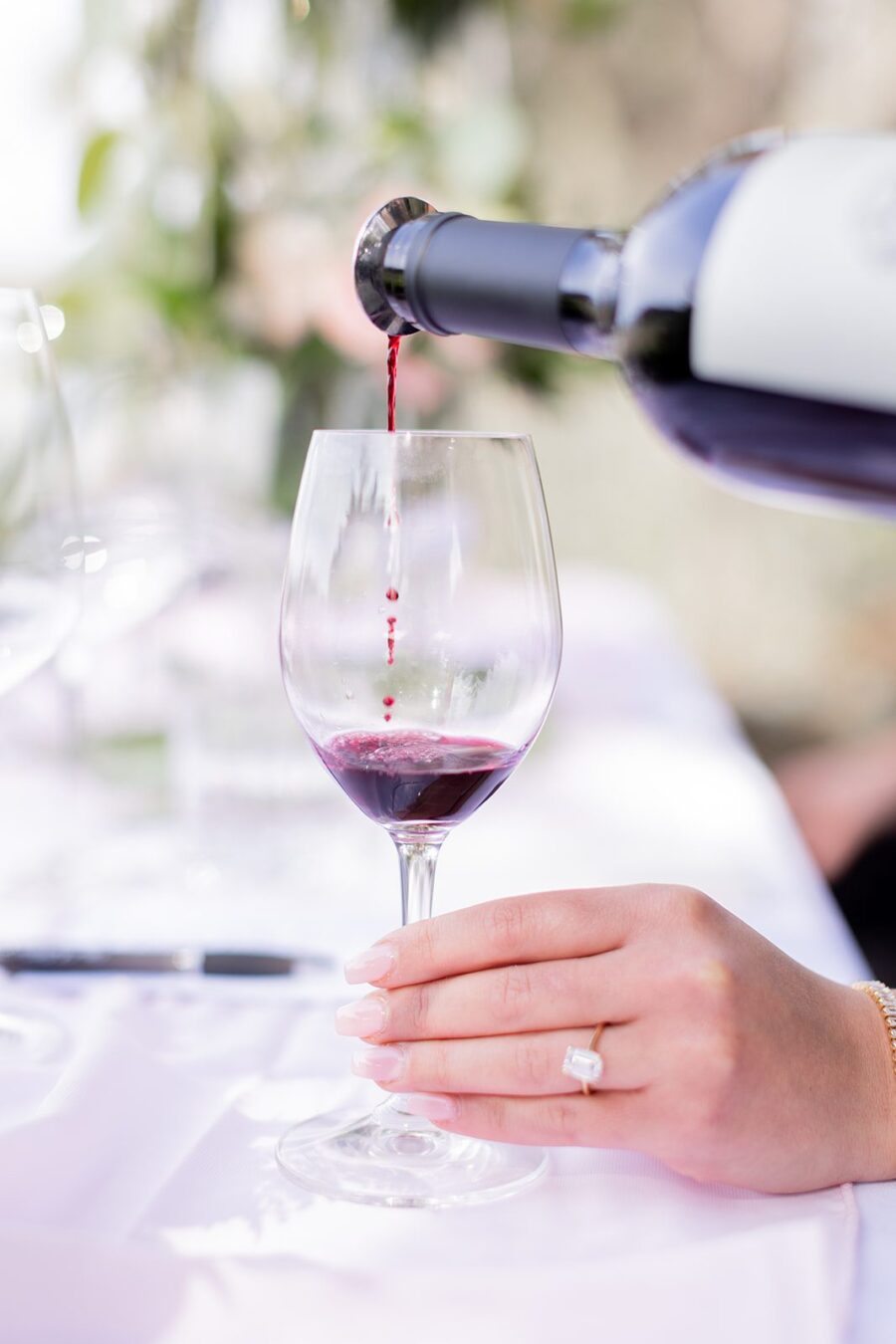 Napa California Winery proposal vineyard proposal wine glass tower custom wine glasses flower garland pouring wine