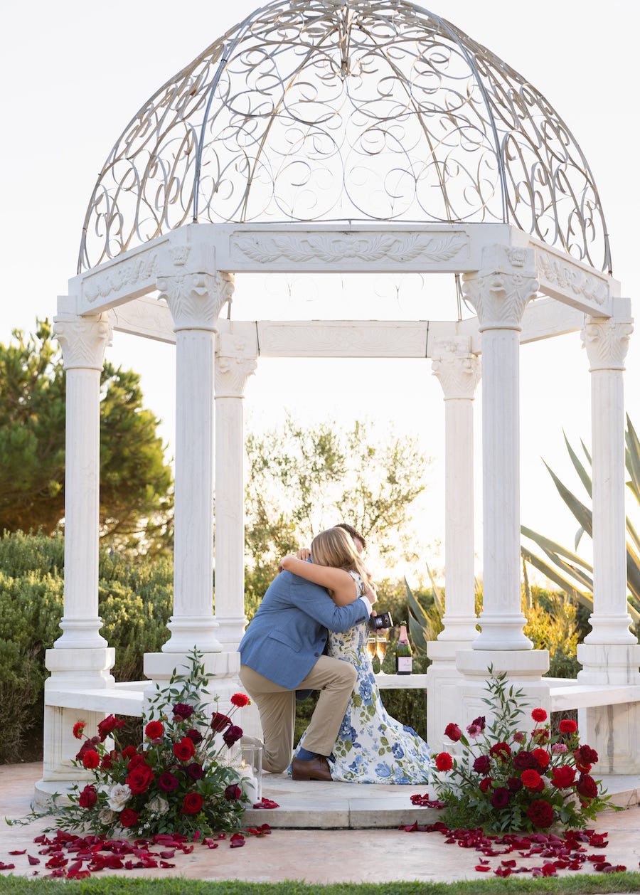 gorgeous gazebo proposal with red roses