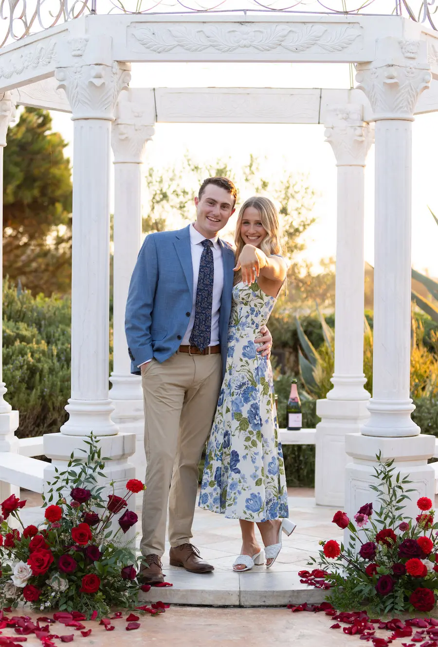 She said "yes"! Gorgeous gazebo proposal with red roses