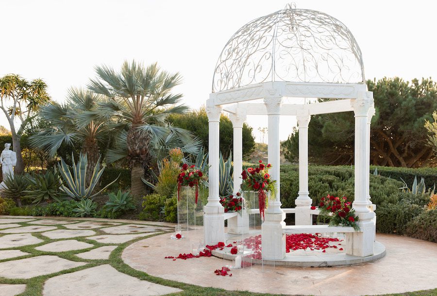 gorgeous gazebo with red roses and candles 