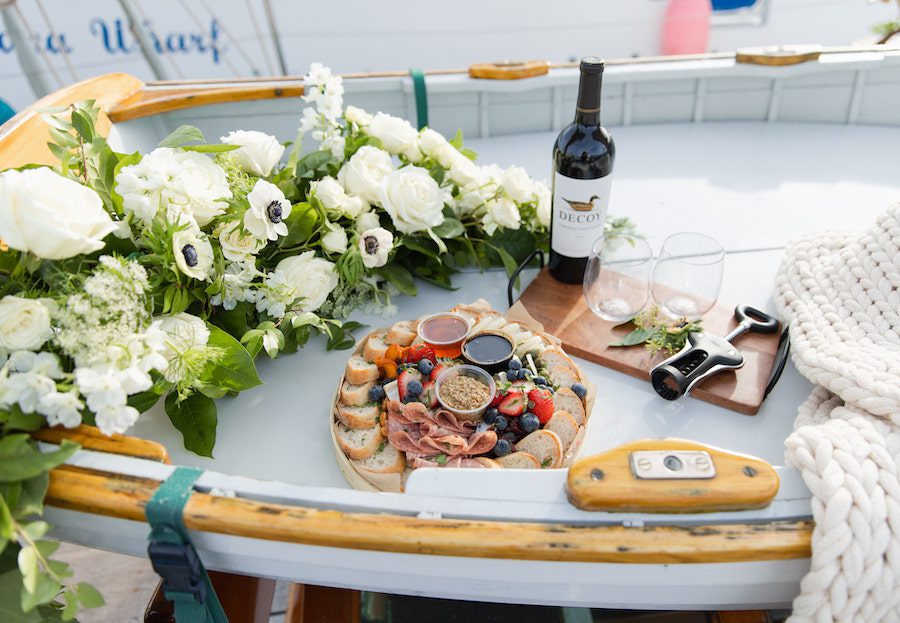 Delicious details on this custom sailboat proposal included a charcuterie board and wine!