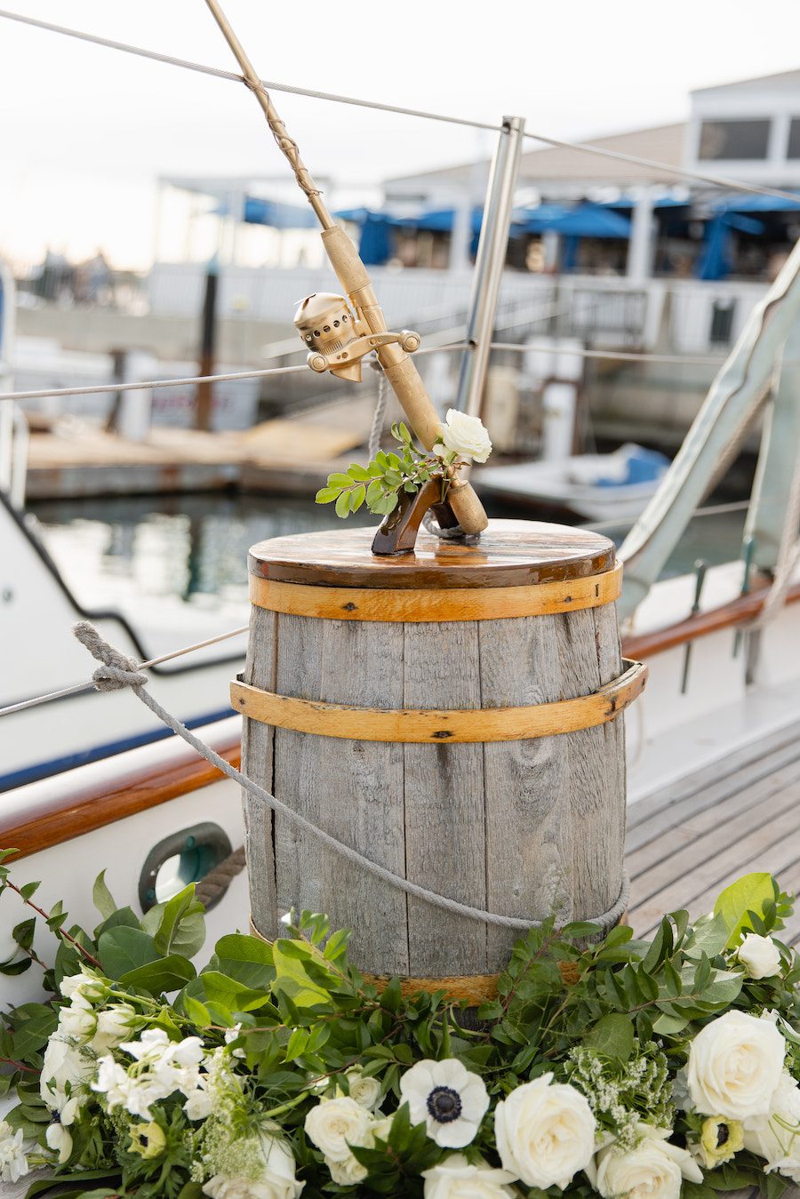 The gorgeous golden fish pole was adorned with florals on the sailboat