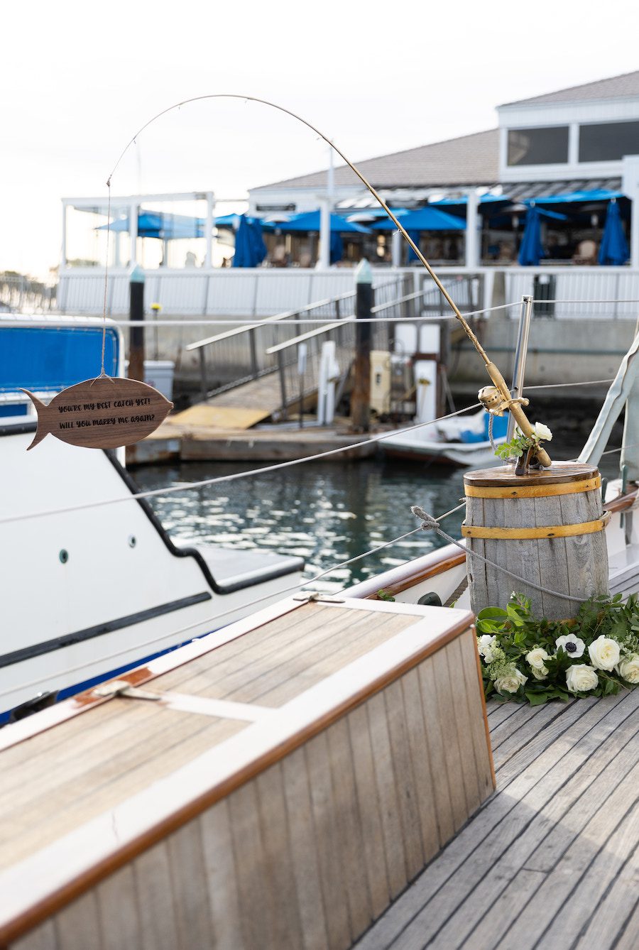 Custom details of this sail boat proposal included a custom fish sign that read "Will you marry me again"