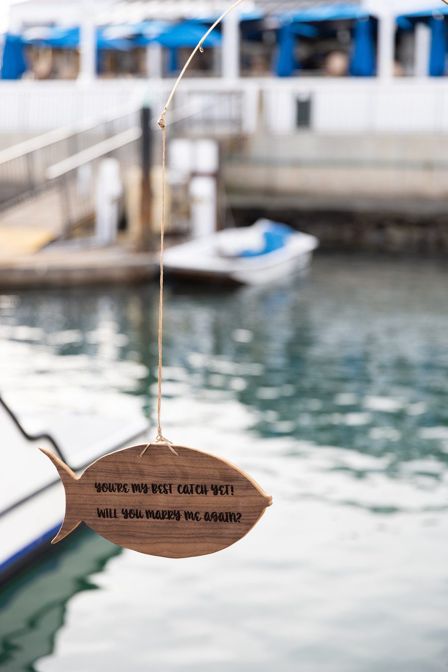 Custom details of this sail boat proposal included a custom fish sign that read "Will you marry me again"