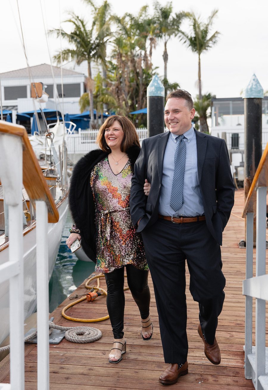 The couple walking up to their gorgeously decorated private sailboat 