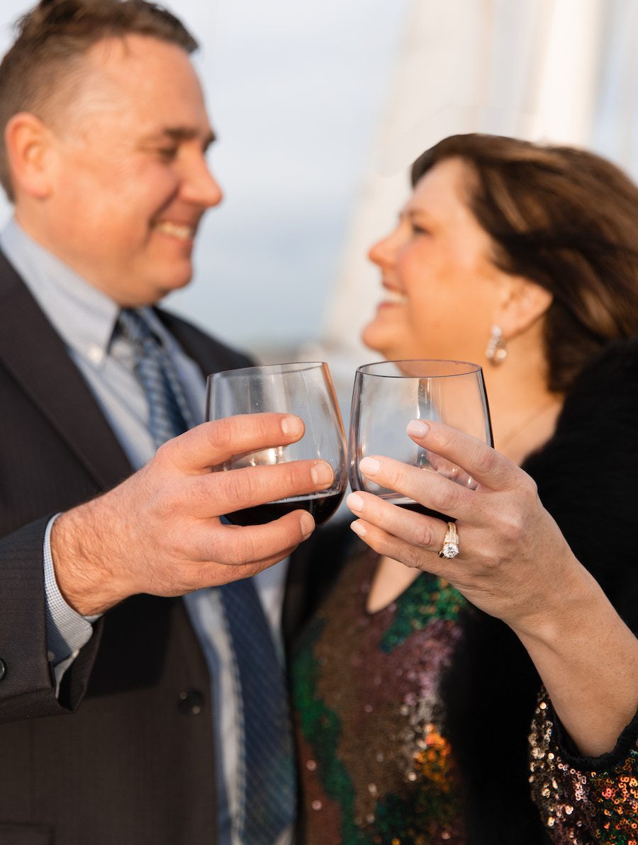 Celebrating their proposal with a glass of wine on their gorgeous sunset sail together