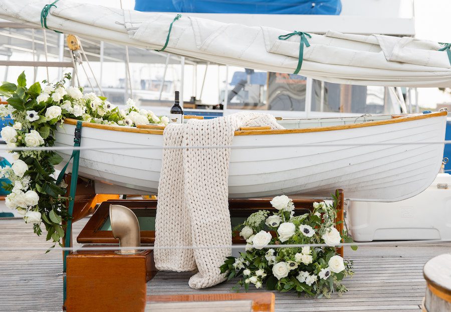Delicious details on this custom sailboat proposal included a charcuterie board and wine!