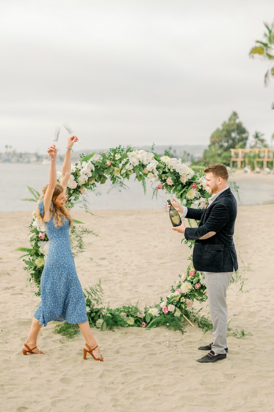 private beach proposal san diego with flower arch by the yes girls