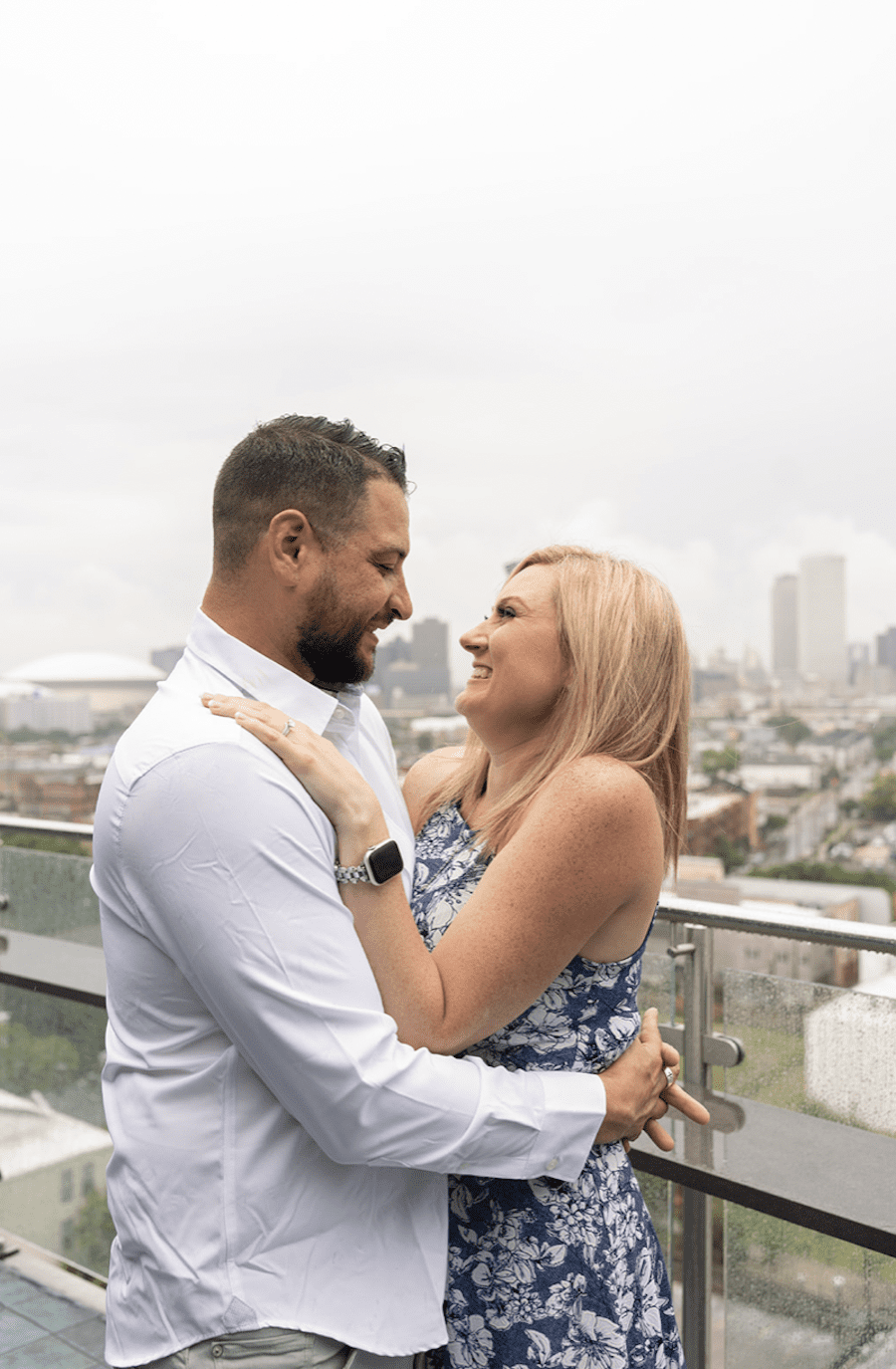 Romantic rooftop proposal in new orleans neutral florals, couple in the rain after she said yes