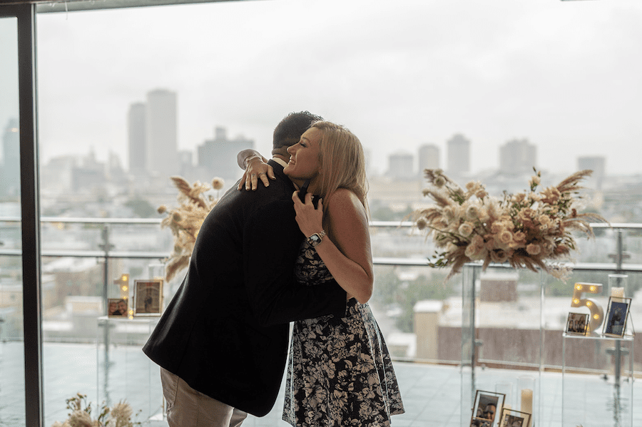 Romantic rooftop proposal in new orleans neutral florals. She said yes!