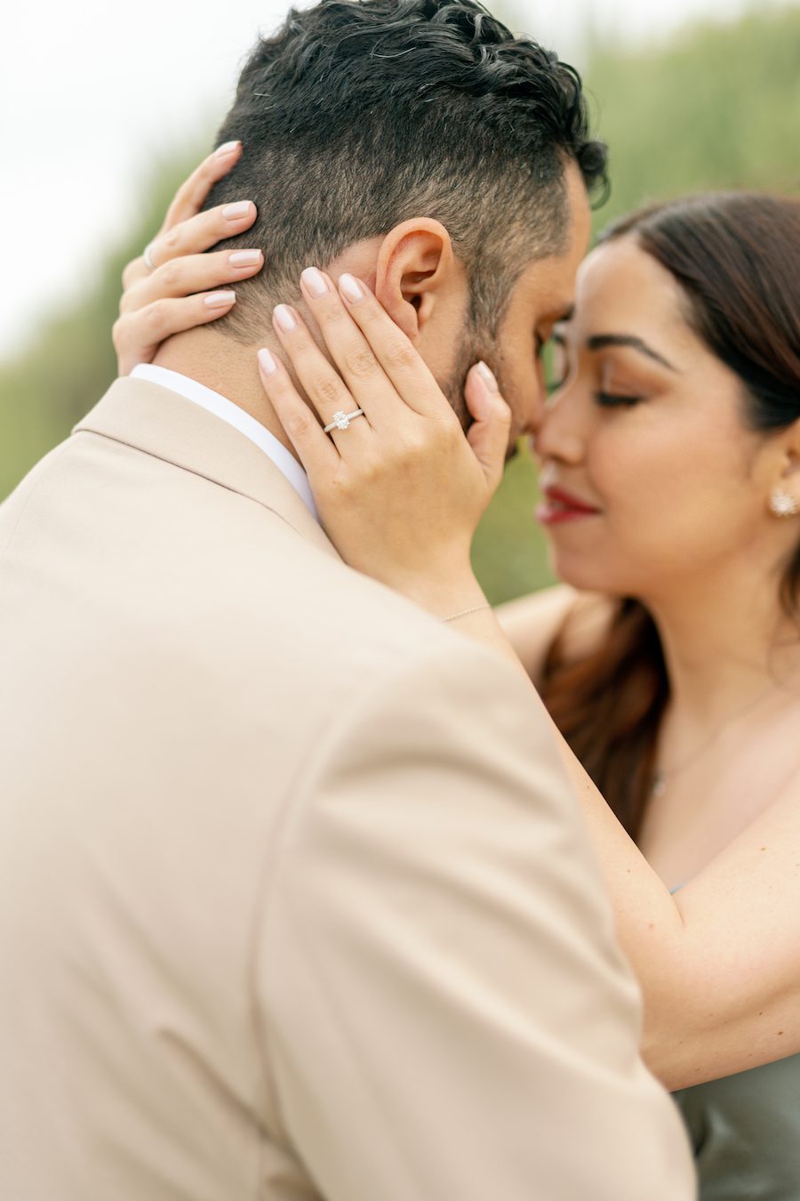 couple kissing after proposal in orange county