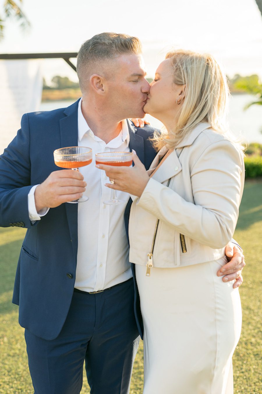 Toasting as a newly engaged couple at this waterfront proposal in San Diego CA